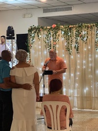 a wedding ceremony in a room with a man and a woman